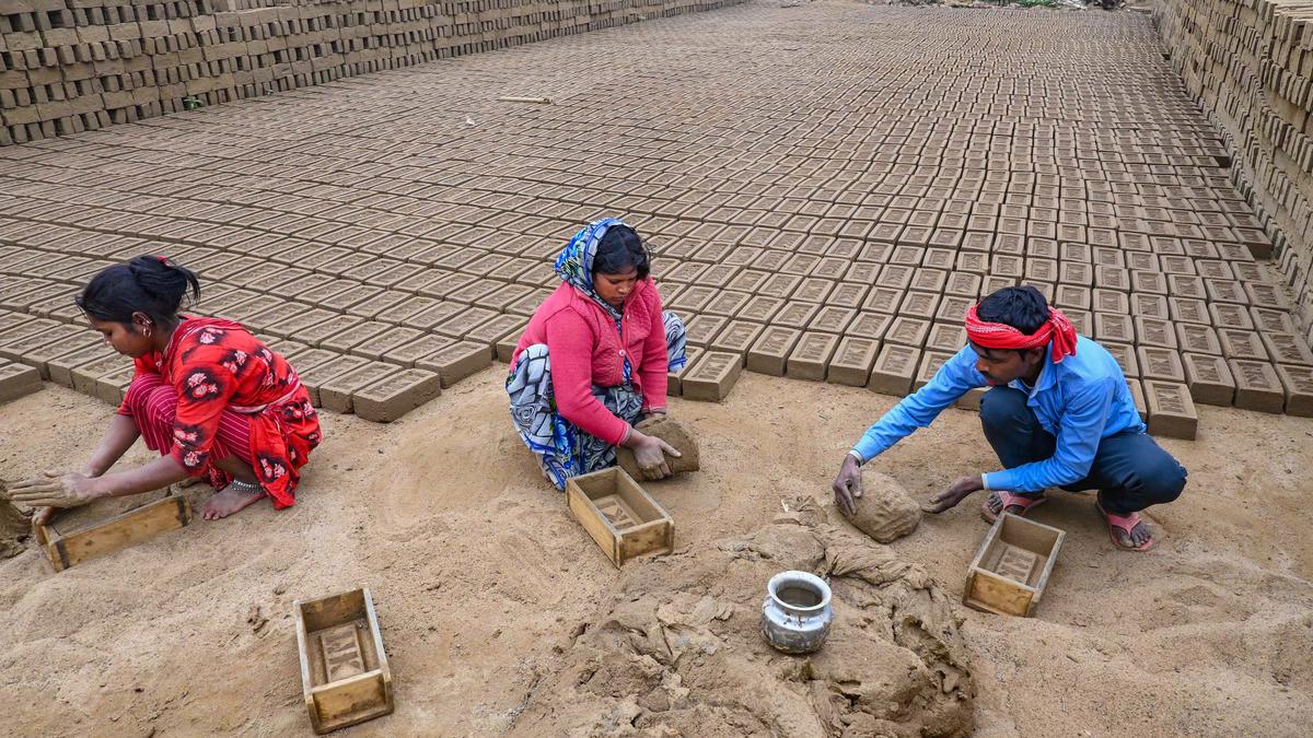 Labourers work at a brick kiln during a cold winter day, on the outskirts of Agartala, on January 10. | Photo Credit: PTI