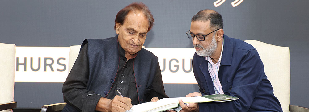 Eminent photojournalist, Raghu Rai signs a copy of his 2015 book, 'Refugees in India' published by the United Nations High Commissioner for Refugees
